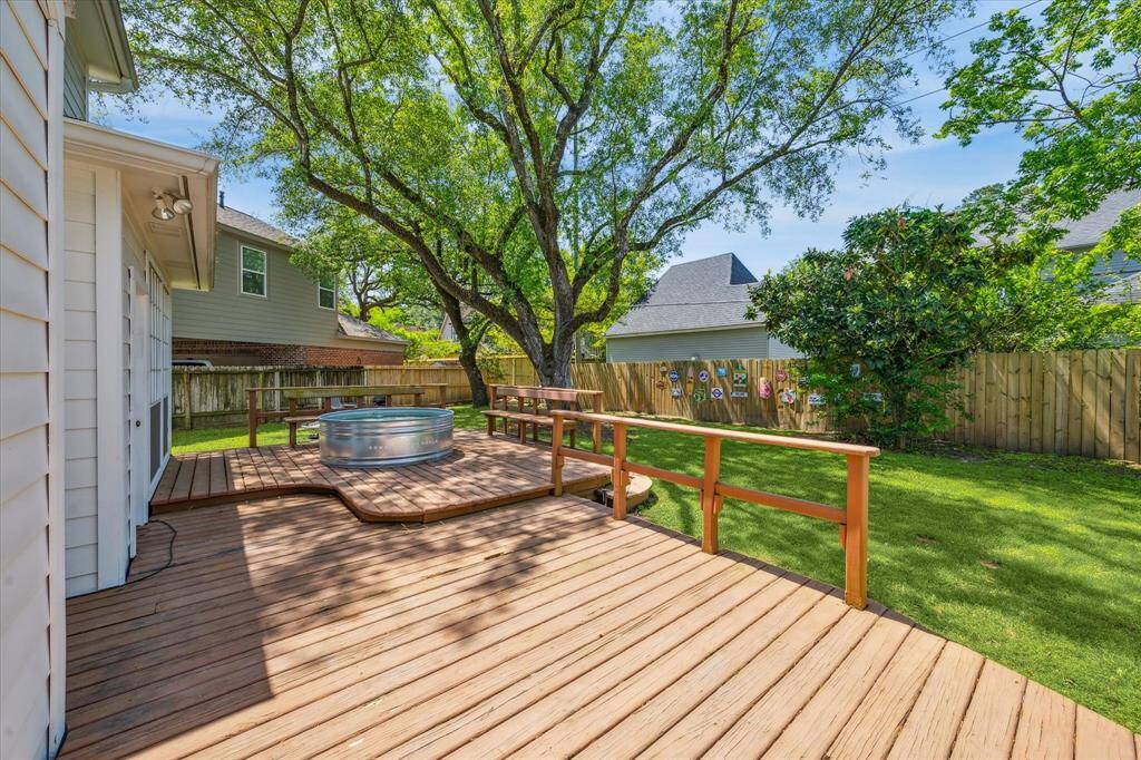 Inviting deck in the backyard, perfect for outdoor relaxation, entertaining, or enjoying the scenery.