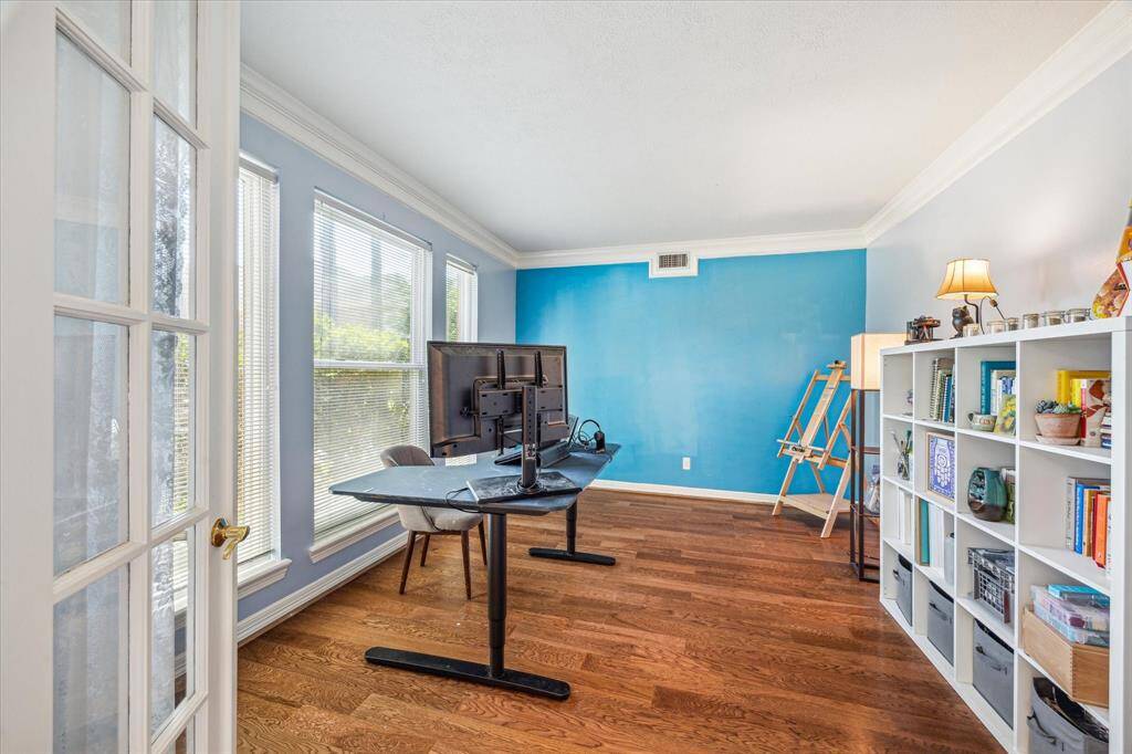 Private home office just off the entryway, featuring elegant double glass doors for a touch of sophistication and natural light.