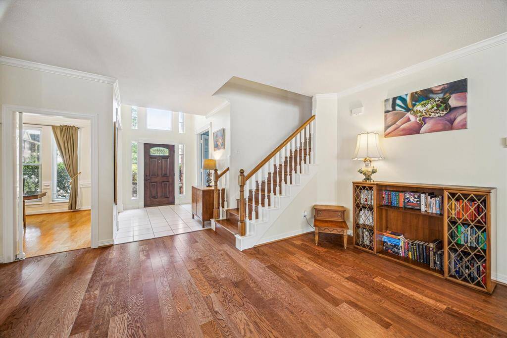 Welcoming entryway opens into a spacious living room, creating a warm and inviting first impression.