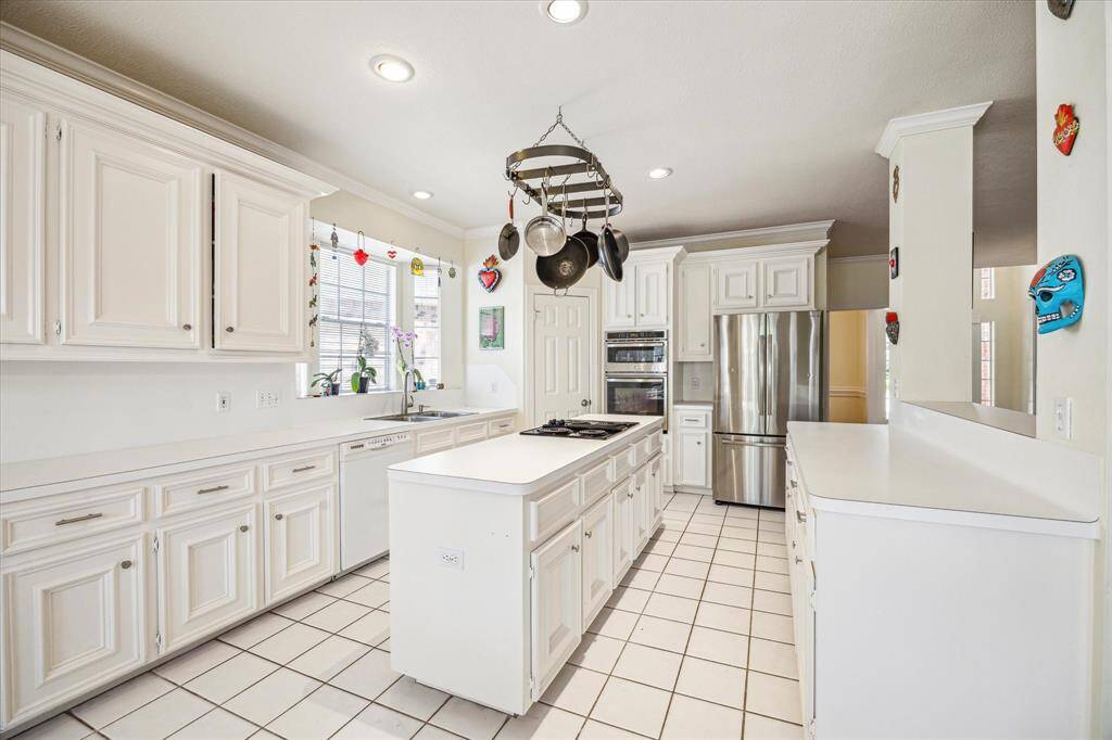 Generously sized kitchen featuring abundant counter space and sleek stainless steel appliances.