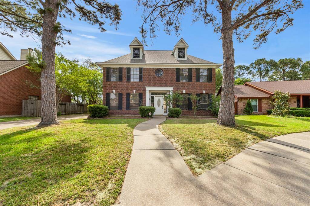 The home is nestled in a quiet, tree-lined neighborhood with great curb appeal.