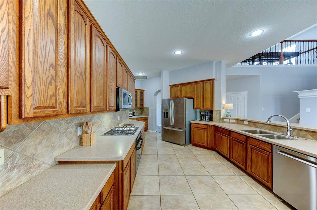 Solid surface counter tops and stainless steel appliances make the kitchen shine with style.