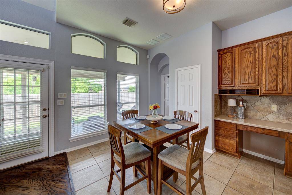 Sunny eating area with pantry behind.