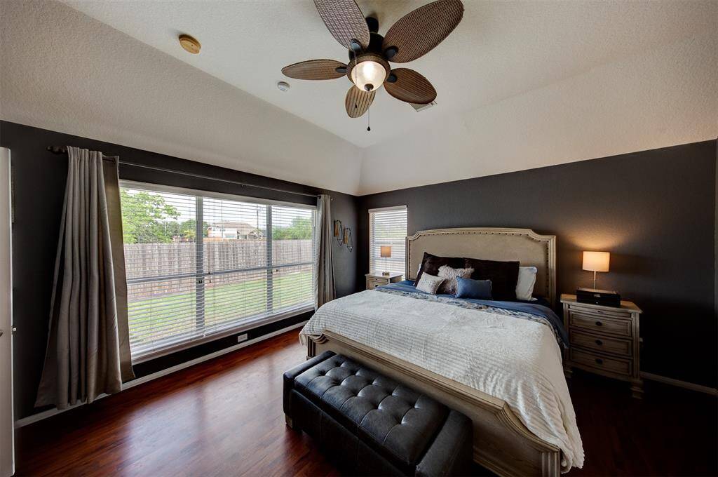 A wall of windows brightens the primary suite.