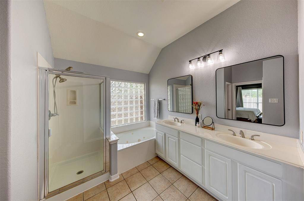 Glass brick wall over the jetted tub provides beautiful light and privacy.