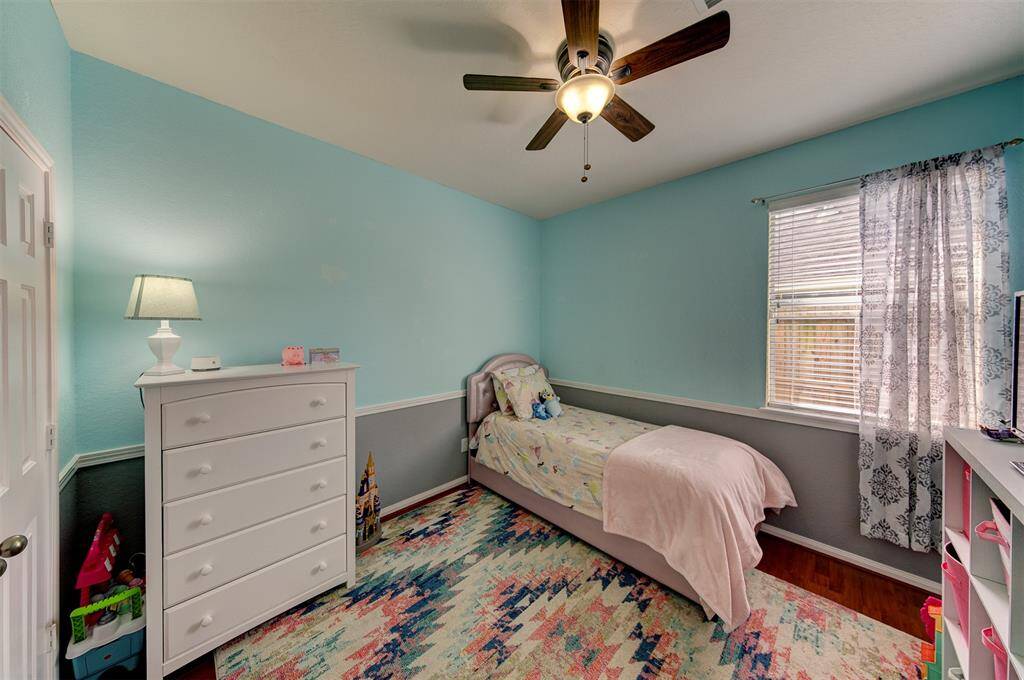 Calming secondary bedroom with chair rail molding.