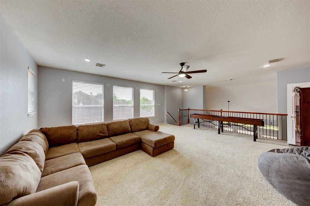 4 bright windows and stunning iron banister in the game room.