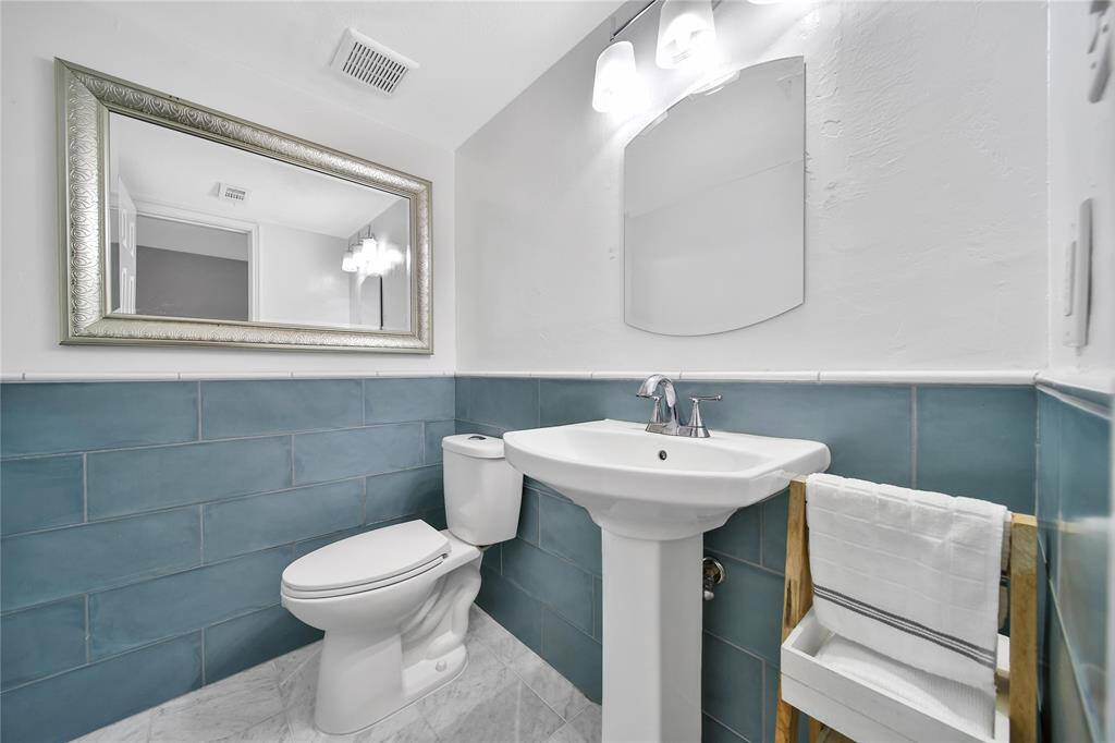 Downstairs half bath with gorgeous finishes.