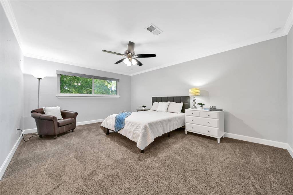 Upstairs primary bedroom with ensuite bathroom and vanity area.