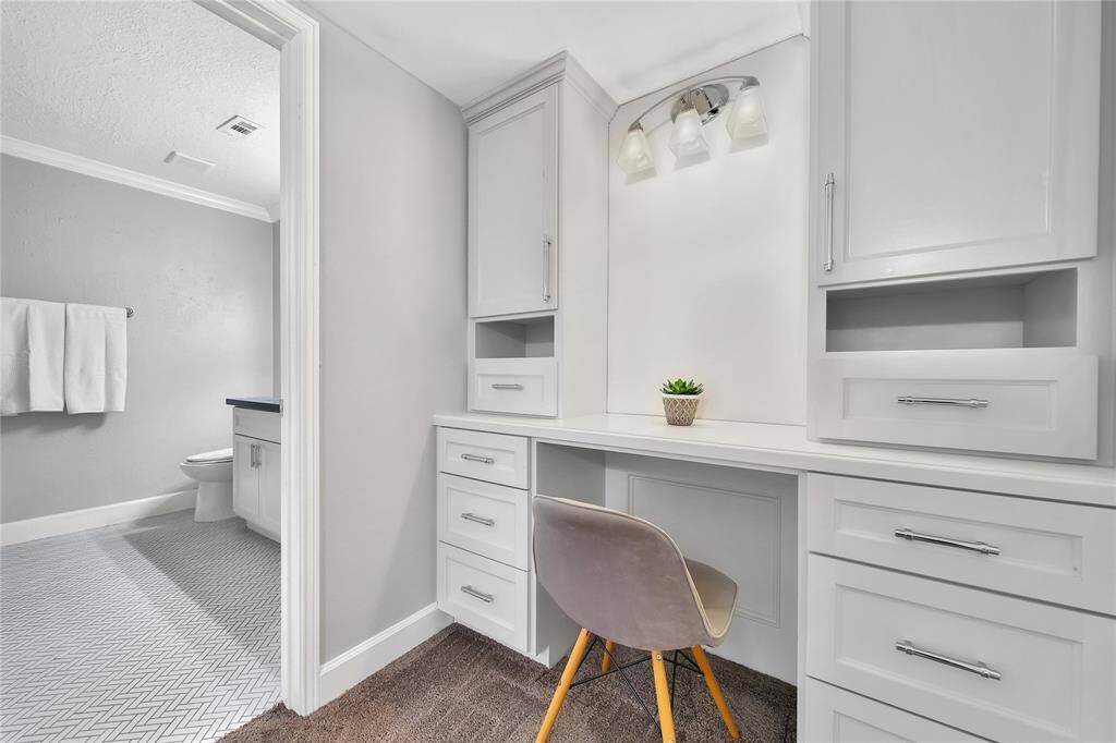 Upstairs primary bedroom with ensuite bathroom and vanity area.
