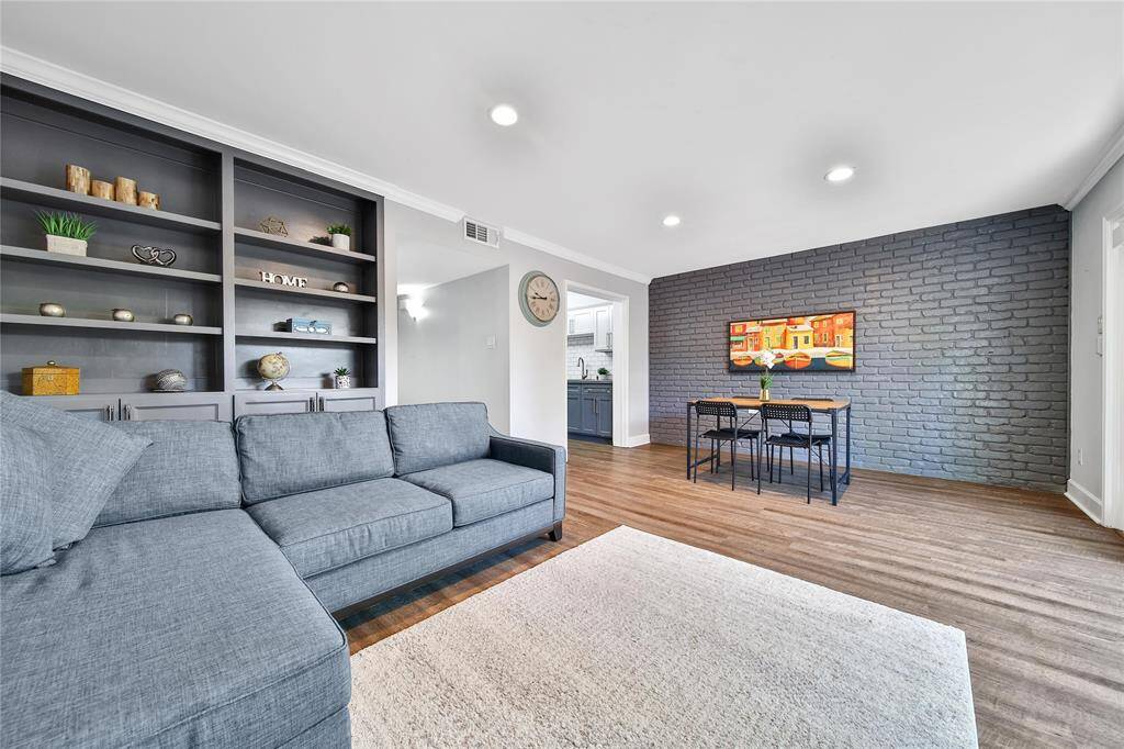 Light and bright family room with built in shelves and a formal dining space.