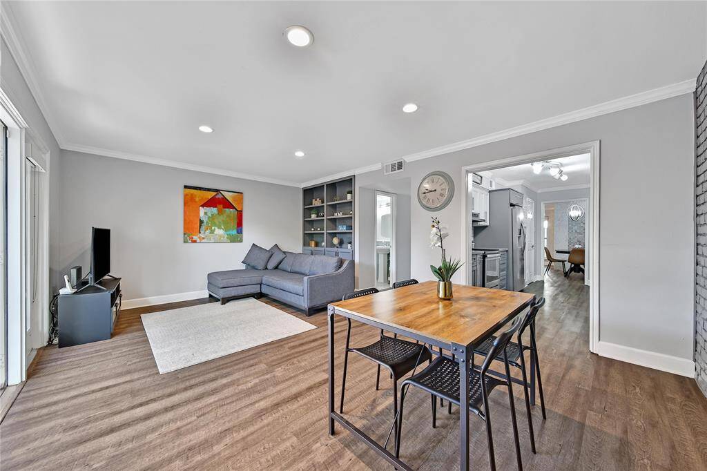 Light and bright family room with built in shelves and a formal dining space.