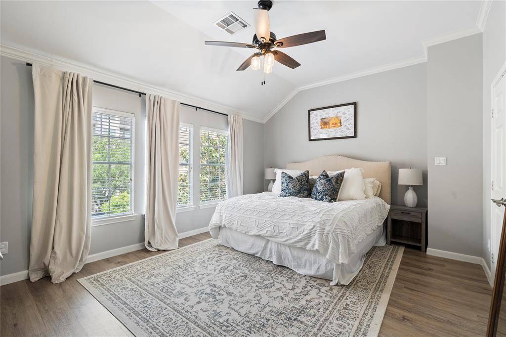 The primary bedroom offers ample space for a seating area, highlighted by a stunning windows. It also boasts a large walk-in closet and soaring ceilings for added elegance