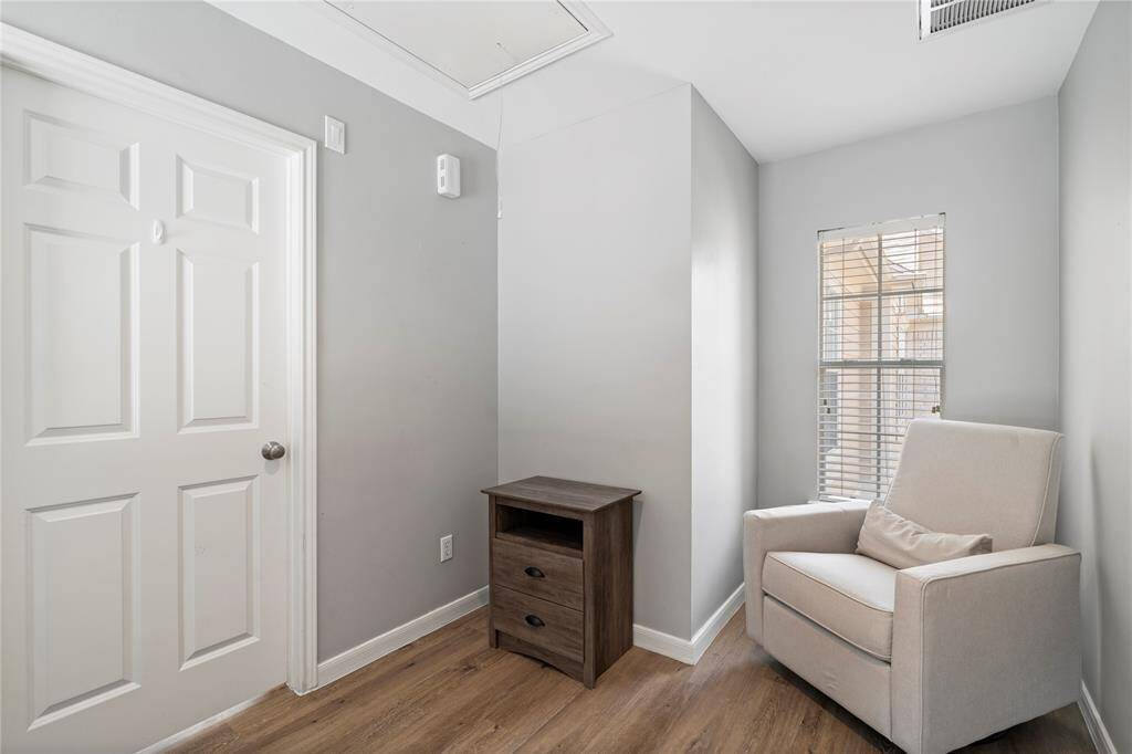 At the top of the stairs on the third floor, you'll find a cozy reading nook. This versatile space is perfect for a small office or reading nook