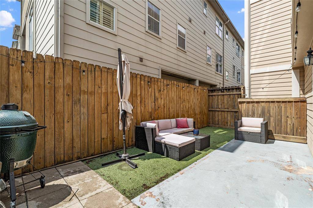 The backyard offers a spacious wrap-around patio, ideal for hosting gatherings, complete with fresh patio pavers and low-maintenance artificial turf.