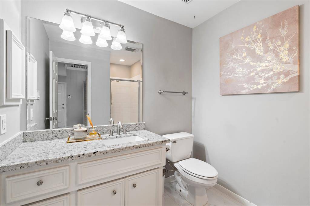 The downstairs full bath with a shower is perfect for guests or a quick refresh before heading out or settling in after a long day.