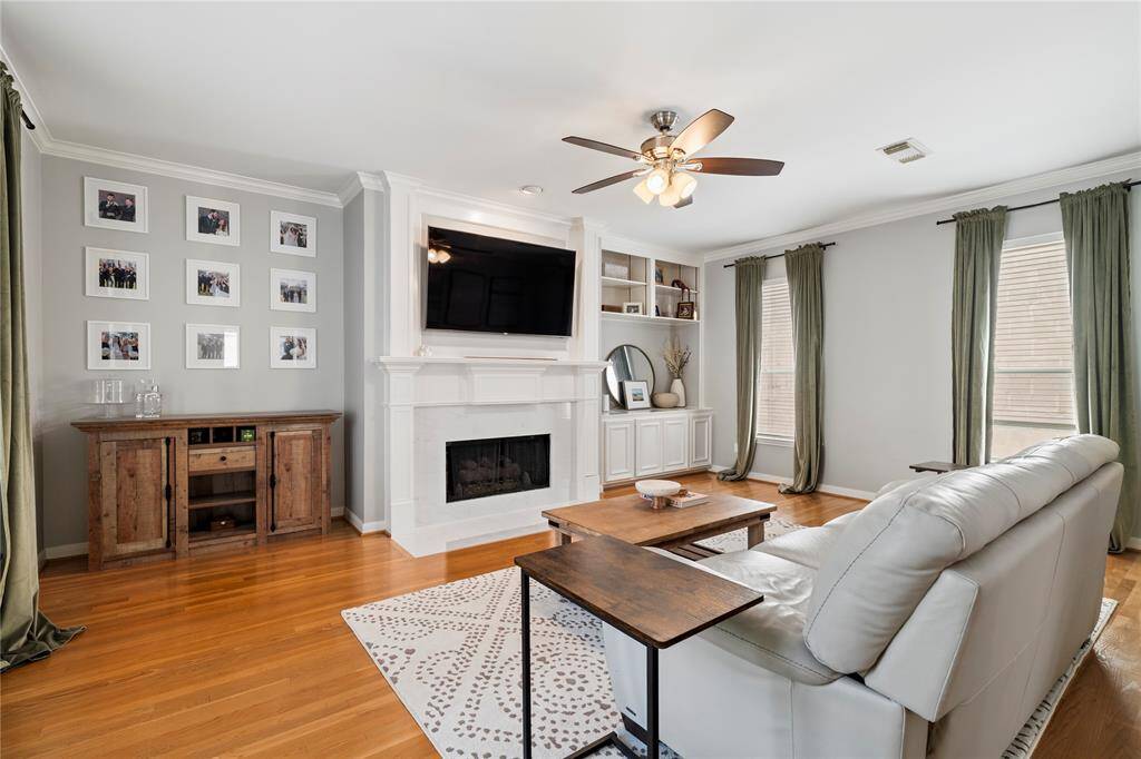 The second-floor living area is spacious and inviting, with a modernized gas log fireplace that sets the perfect mood. Plus, the built-in shelves and cabinets offer extra storage and charm
