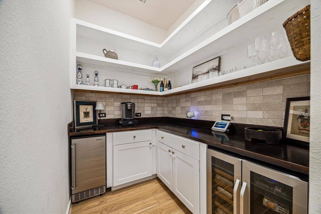 Custom Butlers Pantry features shelving, butchers block countertops, wine Fridge, and separate Ice Maker.