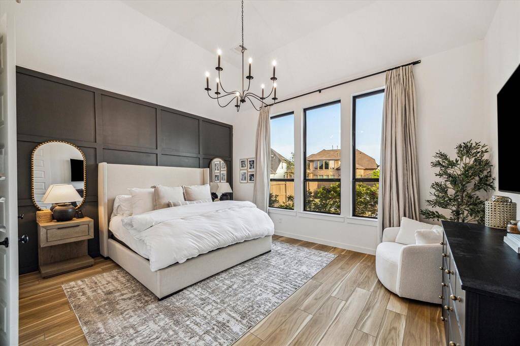 Step into your own private primary retreat! The accent wall and wall of windows really elevate this space!