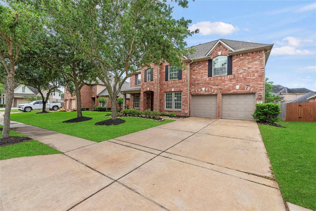 Finely crafted, the elegantly appointed brickwork entices the senses, while the charming stone-bordered flower beds add color and texture to the exterior.
