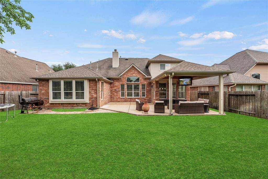 Luscious bright green grass covers the fully fenced-in backyard in an emerald blanket, while the covered patio boasts a television mount. Enjoy watching the game outdoors as you grill and drink cold beverages with your buddies.