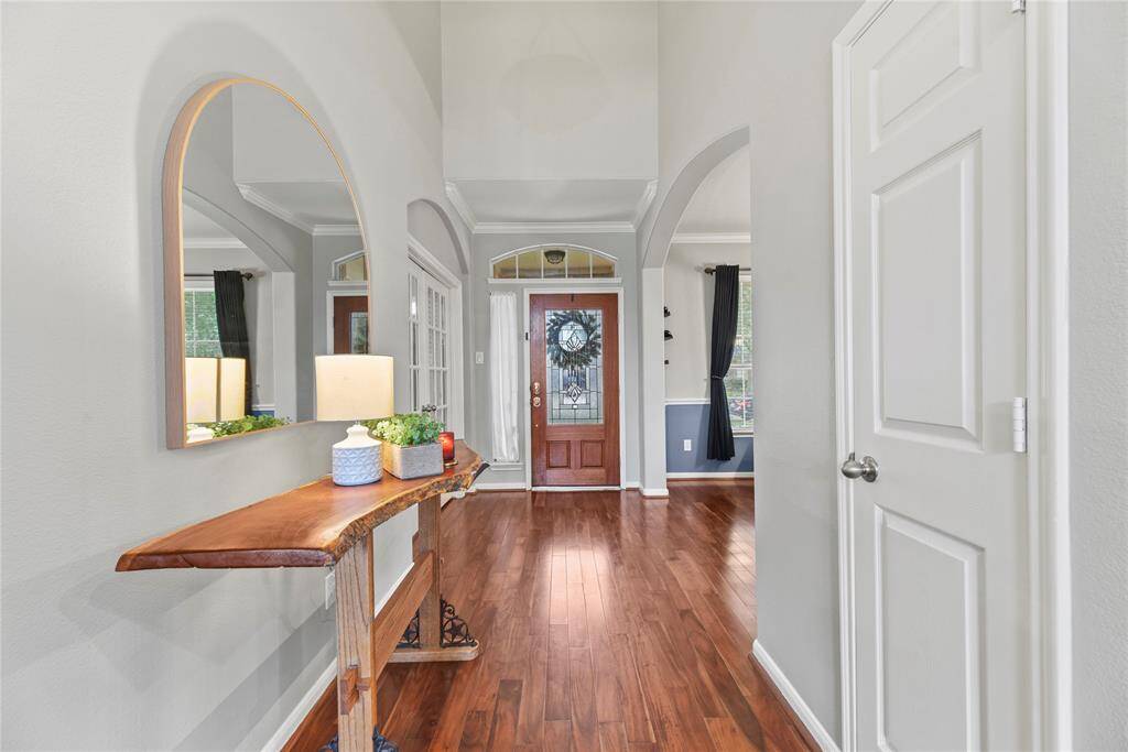 Grand and spectacular, the two-story foyer makes an impression on all your guests! Richly toned hardwood floors gleam in the presence of luminous natural light, while the above light fixture adds a touch of luxury.