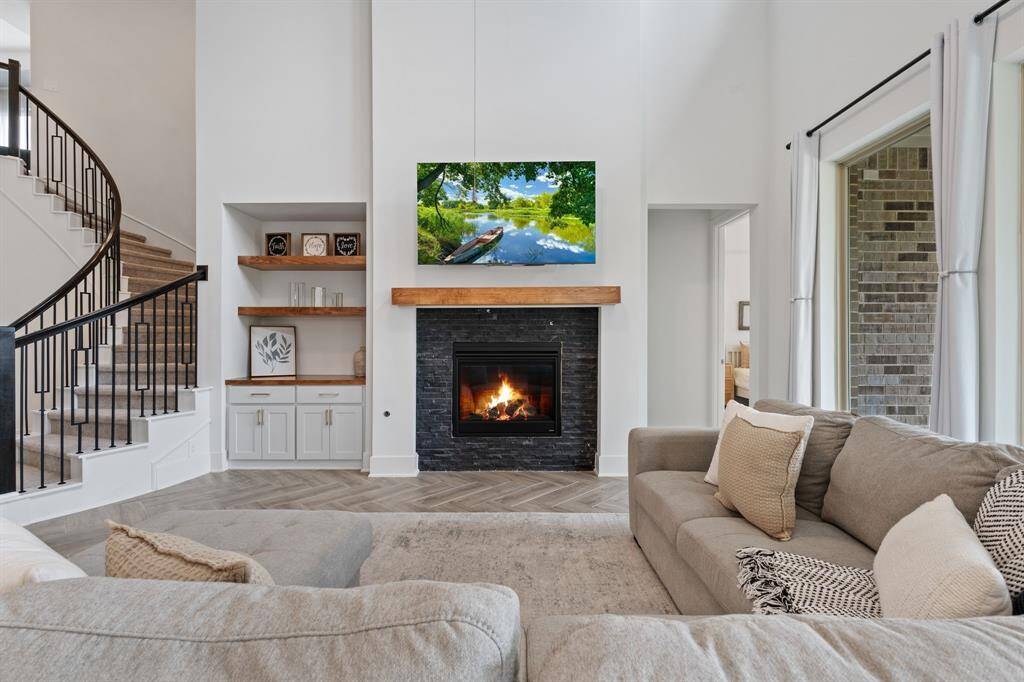 Discover the charm of a custom mantle and elegant cabinetry with shelving, perfectly positioned beside the fireplace.