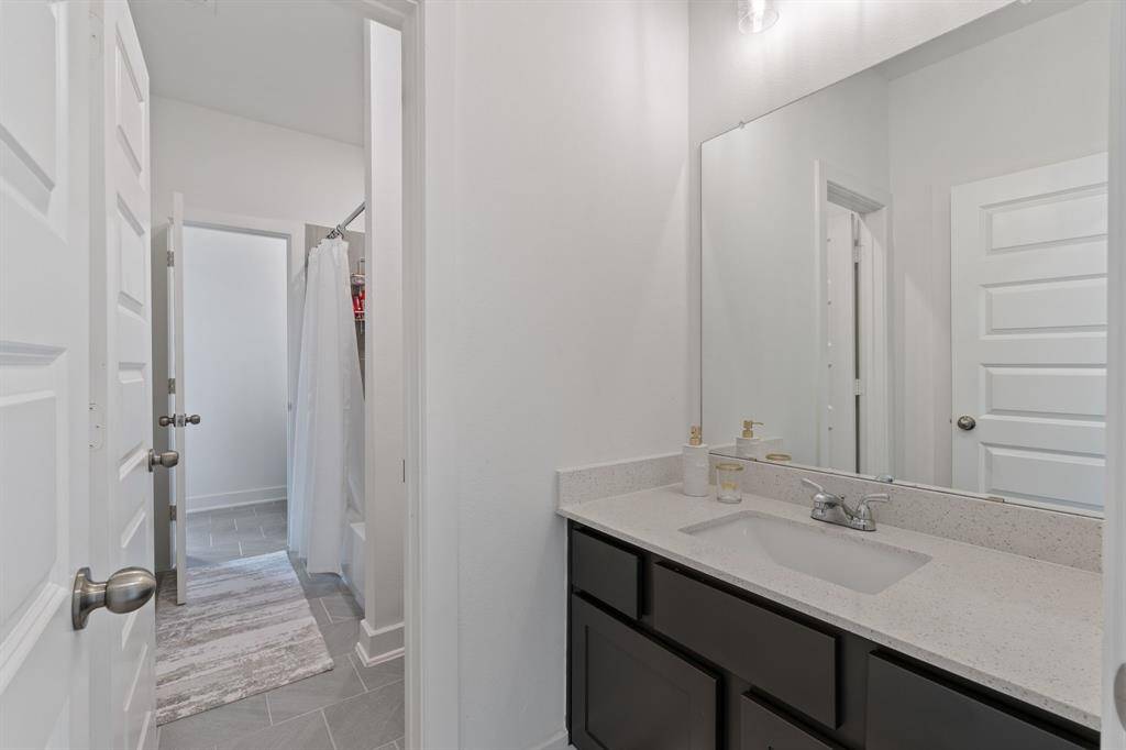 Upstairs bathroom with tub and shower combo.