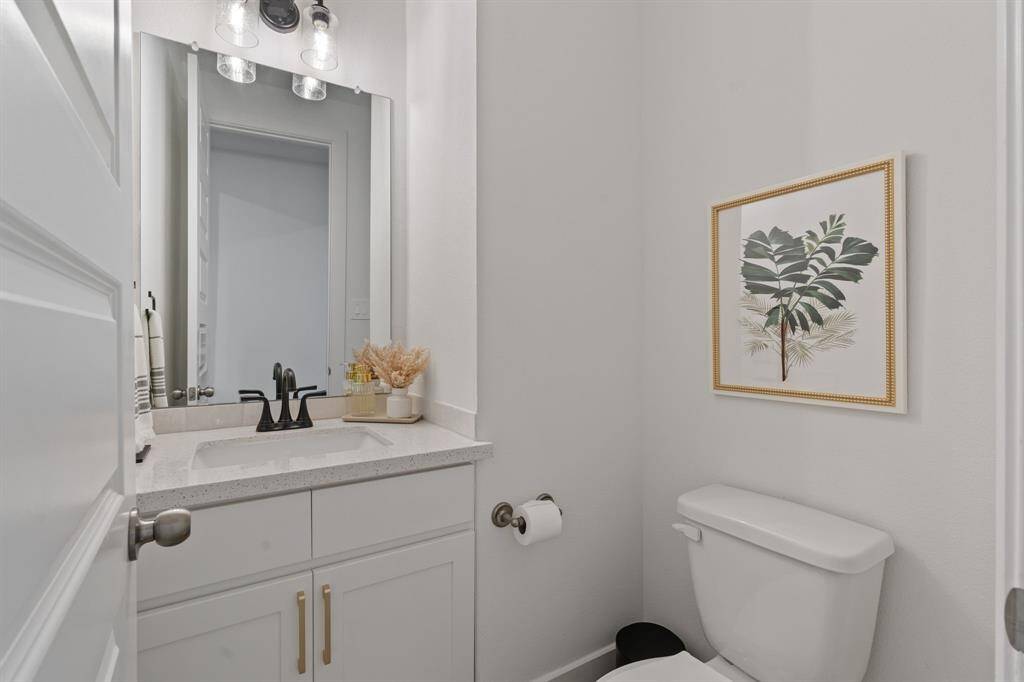 Modern and stylish powder room featuring elegant fixtures and a chic design, perfect for guests.