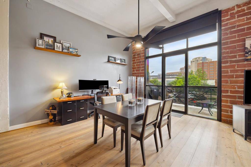 Dining area just off kitchen is flooded with natural light from the wall of windows.