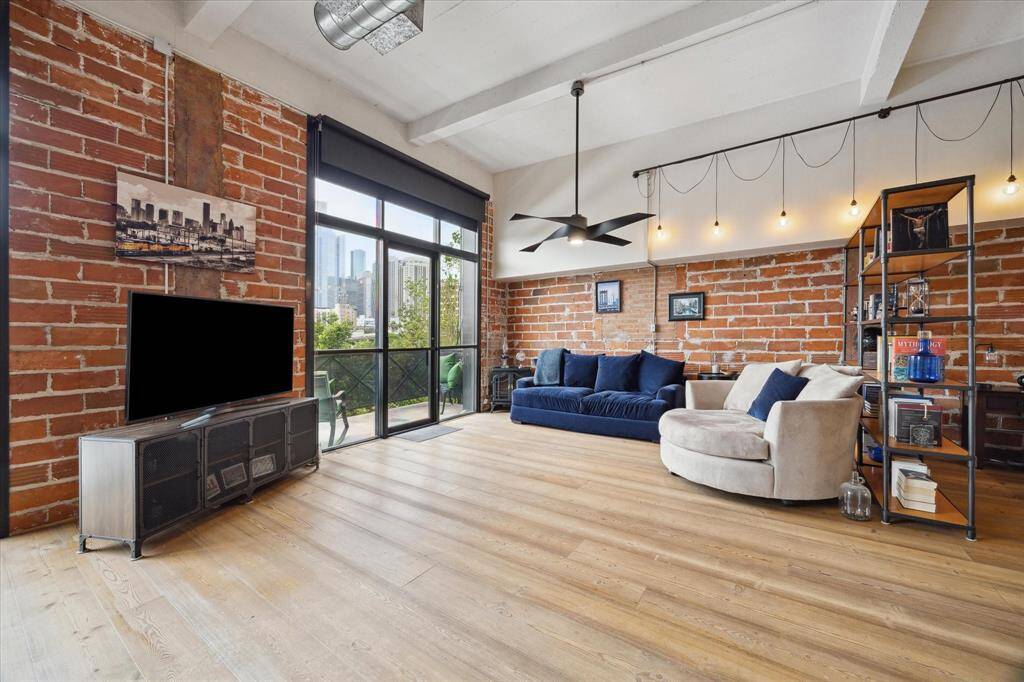 The living area has its own balcony with a wall of windows.