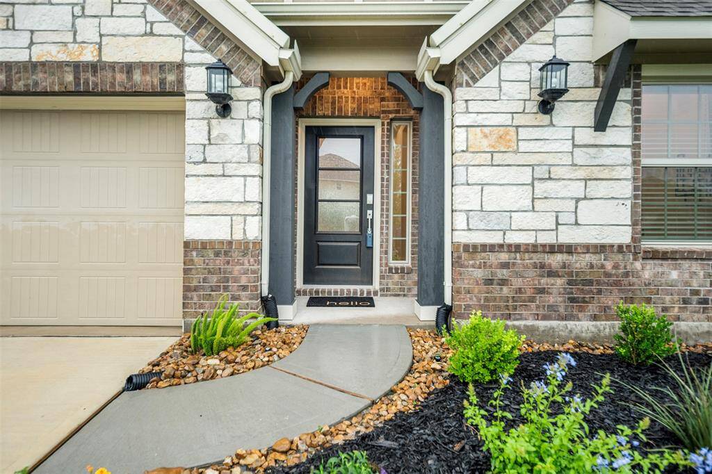 Beautiful brick and stone elevation and fresh landscaping.