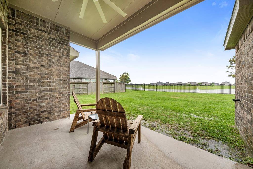 Covered back patio onlooking the neighborhood lake!