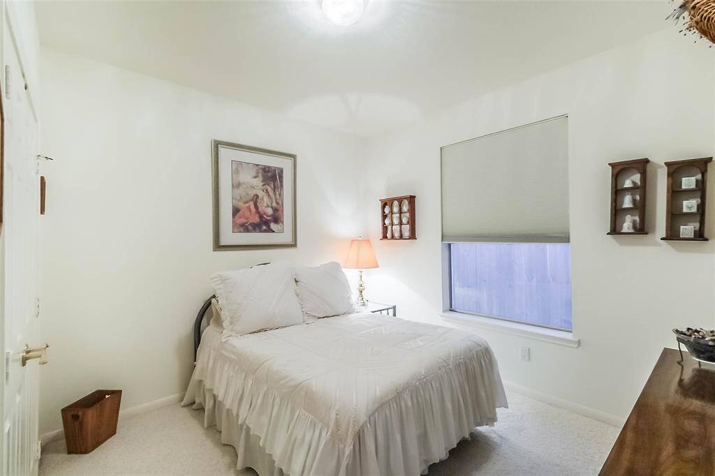 This cozy bedroom features neutral walls and carpeting. Perfect for a guest room or personal retreat.