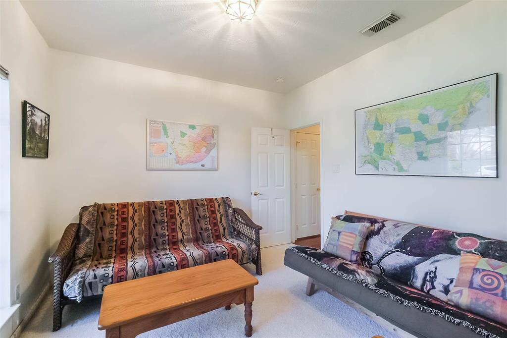 Currently being used as a sitting room, this can also be used as a bedroom. Hallway to the right provides easy access to linen closet as well as a shared full bath.