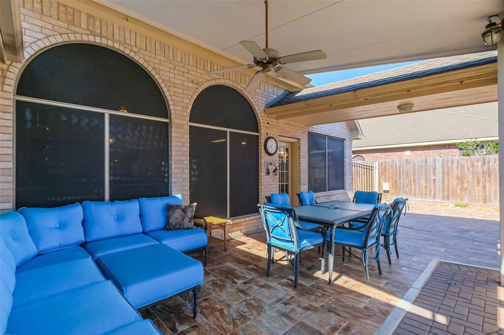 Another view of the outdoor patio features the tile entry to the garage on the right.