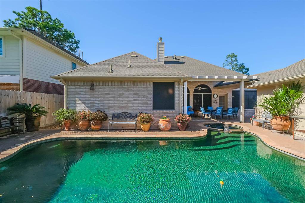 Inviting pool features Pebble Tec finish creating the gorgeous emerald oasis.