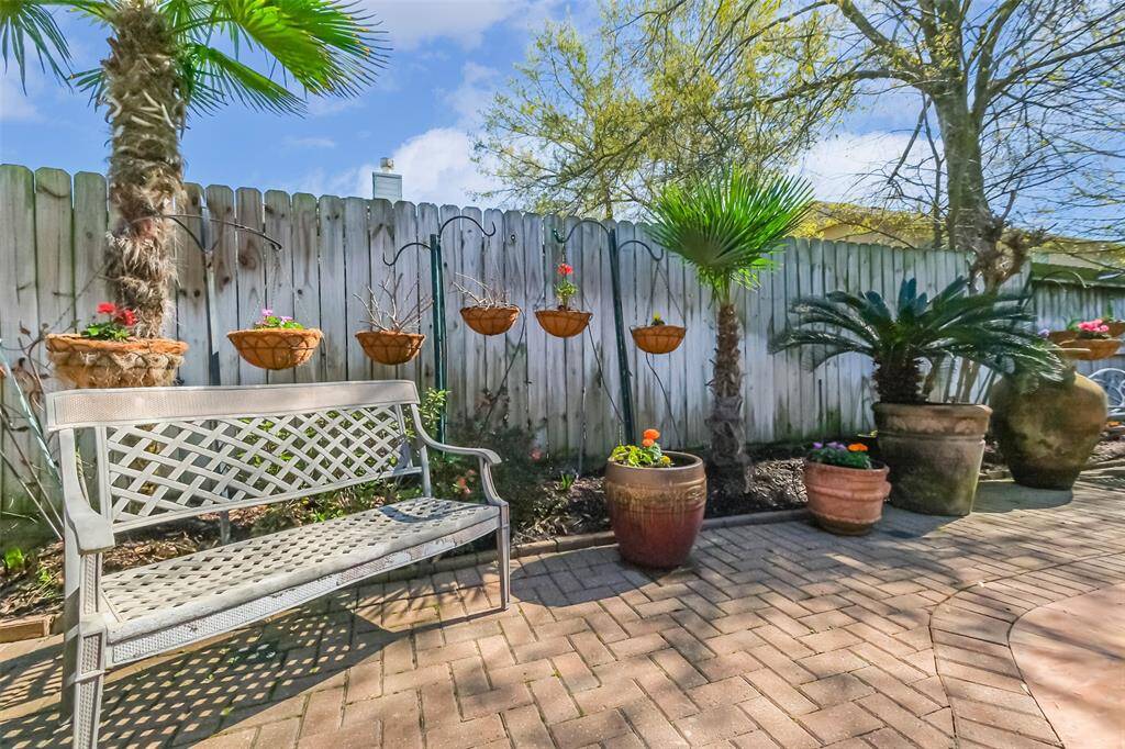 Lush landscaping surrounds the backyard pool.