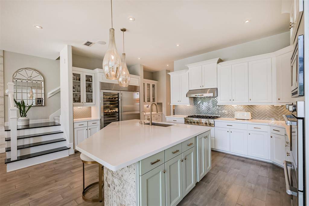 The chef's dream kitchen was remodeled in 2020 to accommodate a large Sub-Zero refrigerator and wine cooler, deep stainless steel sink with brushed gold faucet & filtered drinking water tap.