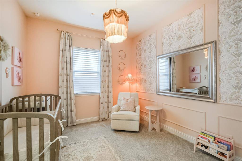 The secondary bedroom down has been decorated as a beautiful nursery for their little princess but there is plenty of room to accommodate a large bed to use as a ground-floor guest room.