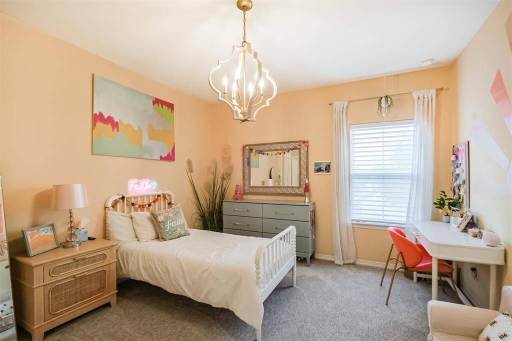 This lovely room features a stylish pendant light and warm paint tones.