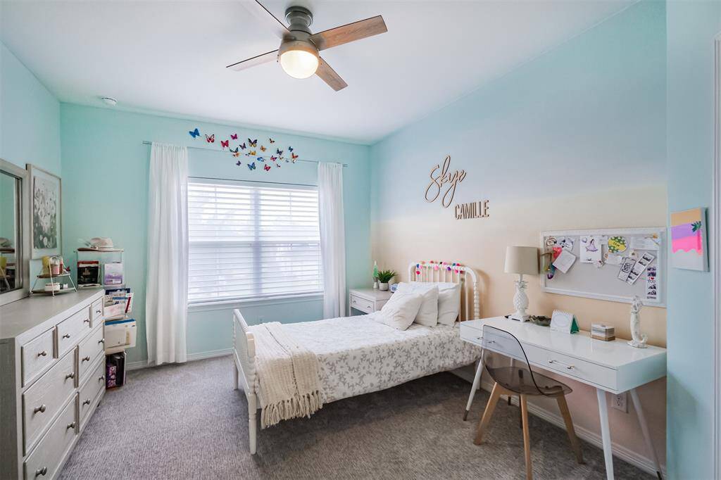 The third and largest of the 3 secondary bedrooms upstairs with large window and ceiling fan. Hunter-Douglas Zebra-style blinds throughout the house cover most windows.