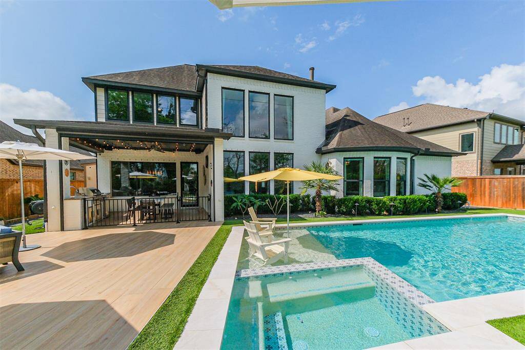 The custom pool boasts a 6 person spa and tanning shelf