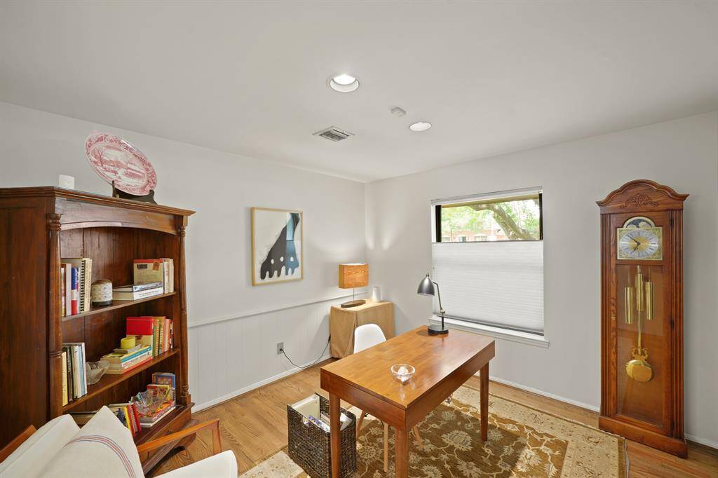 The Office features a Picture Sized Window (with Pleated Shade) that views the Landscaped Front Yard and the Mature Oak Trees.