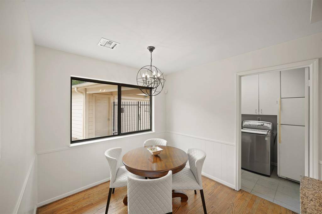Additional Features in the Breakfast Room include White Painted Wainscotting and a Picture Sized Slider Window that views the Outdoor Patio, Pool, and the Yard.