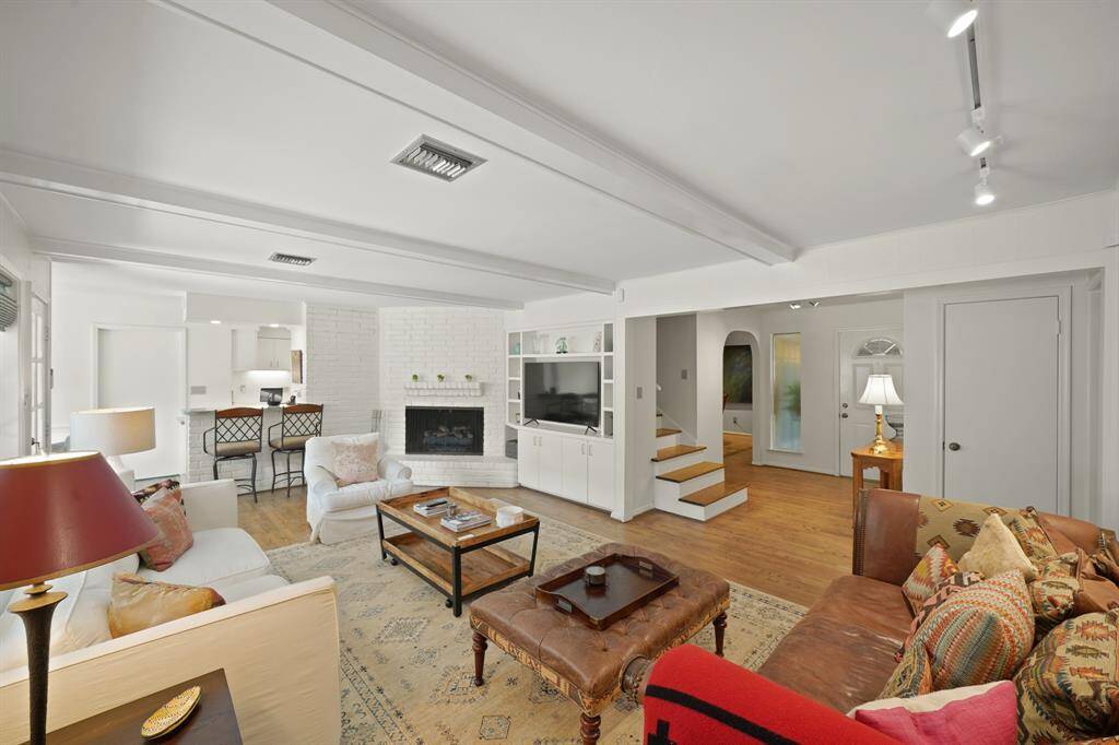 The Open Flow between the Living Area, Kitchen and Breakfast Area is so Convenient for Entertaining Friends as well as Everyday Living!  The Living Area (Approximately 19'3" x 14'10") offers Red Oak Hardwood Floors (2019 per Seller) and Halogen Art Spot Lighting.
