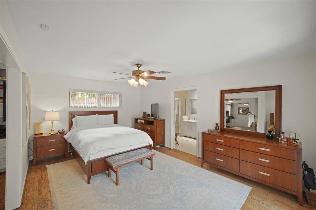 The Primary Bedroom (Approximately 17' x 11'11") features Red Oak Hardwood Floors (2019 per Seller) and Vertical Blinds.