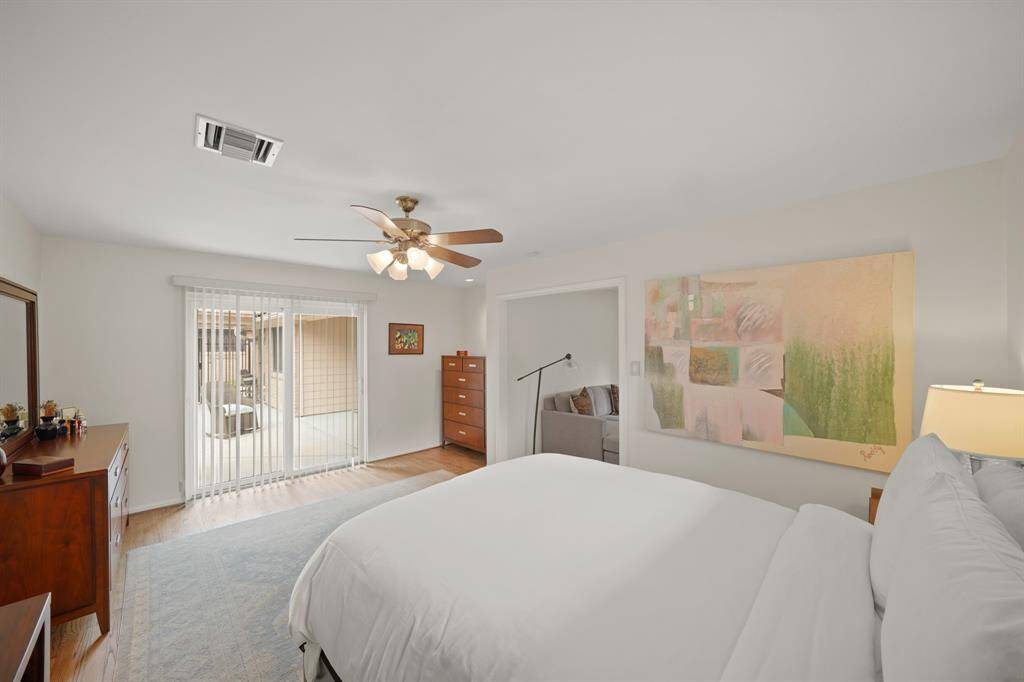 A Sliding Glass Door in the Primary Bedroom opens to the Outdoor Patio, Pool and the Yard.  The Primary Bedroom is located adjacent to, as well as being open to, the Second Bedroom. Per Seller, the Opening between the Primary Bedroom and the Second Bedroom can be closed as Originally Constructed so that it can serve as a Private Primary Suite.