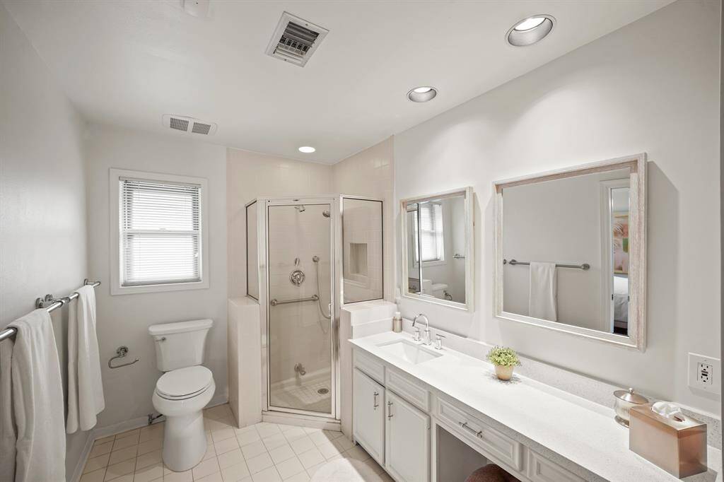 The Primary Bath features a Silestone Topped Vanity (2019*), Undermount White Porcelain Sink (2019*), and Polished Chrome Faucet and Handles (*per Seller).  A Walk in Shower with Tile Surround, Built in Shampoo Shelf, Shower Head, and Separate Hand Held Wand, is also featured in the Primary Bath.