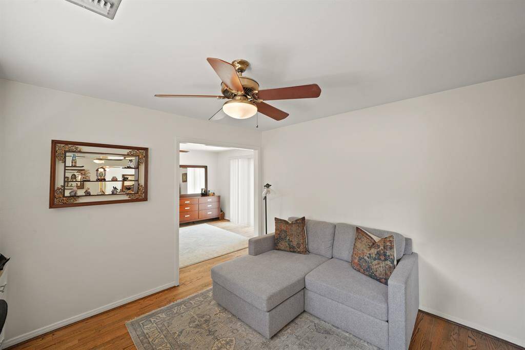 The Second Bedroom/Flex Room features Red Oak Hardwood Floors (2019*) and Ceiling Fan with Wood Style Blades and Light (*per Seller).
